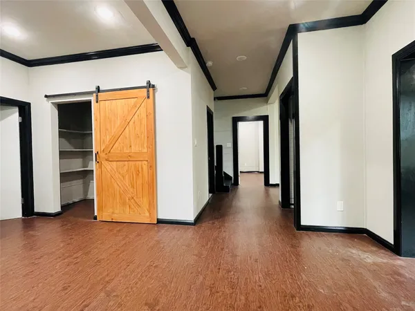 a view of a room with wooden floor