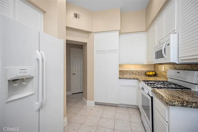 a kitchen with stainless steel appliances granite countertop a sink and a stove