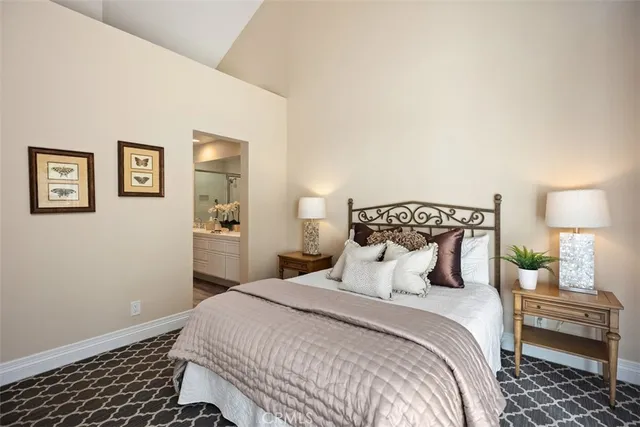 a bedroom with a bed and a lamp on table