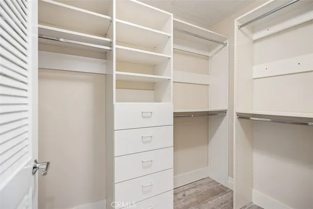 a view of walk in closet with empty racks