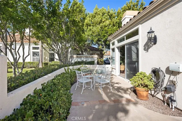 a view of a patio with table and chairs and potted plants