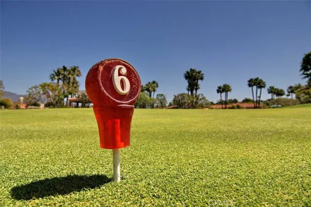 a swimming pool with an outdoor space and seating area