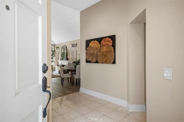 a living room with furniture and a painting on the wall