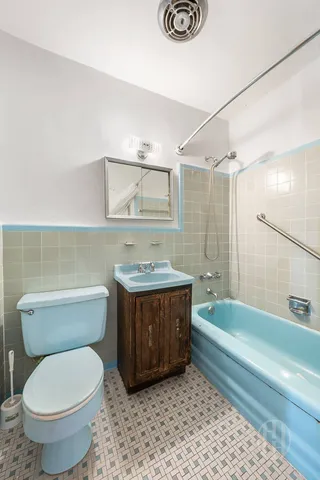 a bathroom with a granite countertop toilet a sink and bathtub