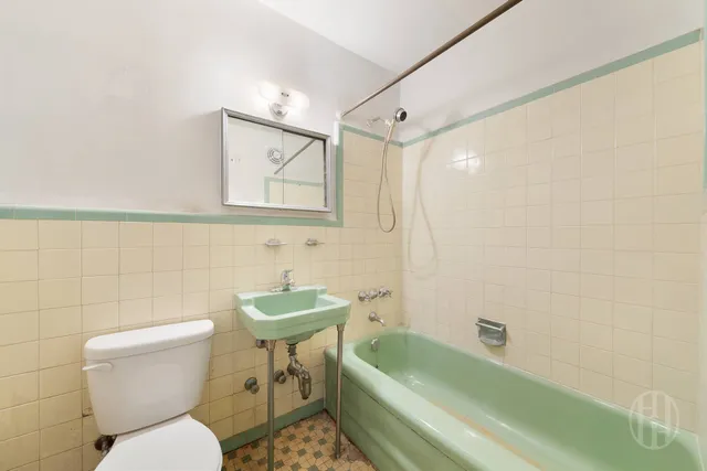 a bathroom with a sink mirror bathtub and toilet