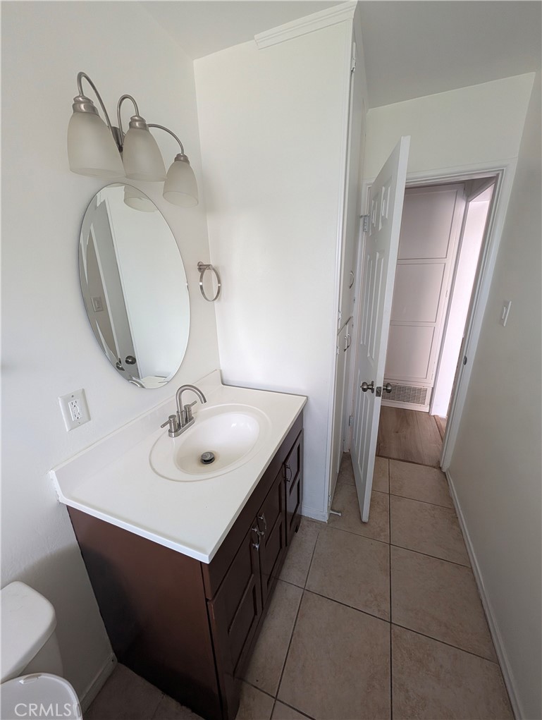 8641 Garfield Street Riverside, CA 92504 - Photo 12 of 19 a bathroom with a sink and mirror
