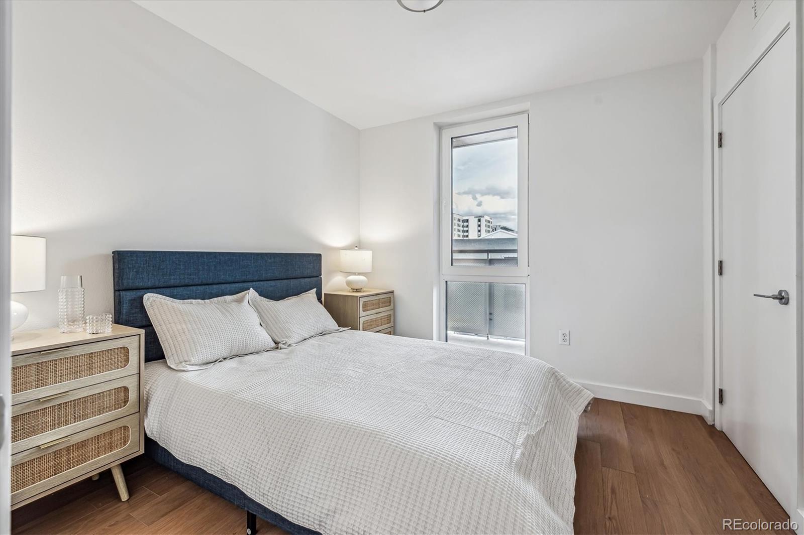 3575 Chestnut Place, Unit 605 Denver, CO 80216 - Photo 9 of 11 a bedroom with a bed and a window