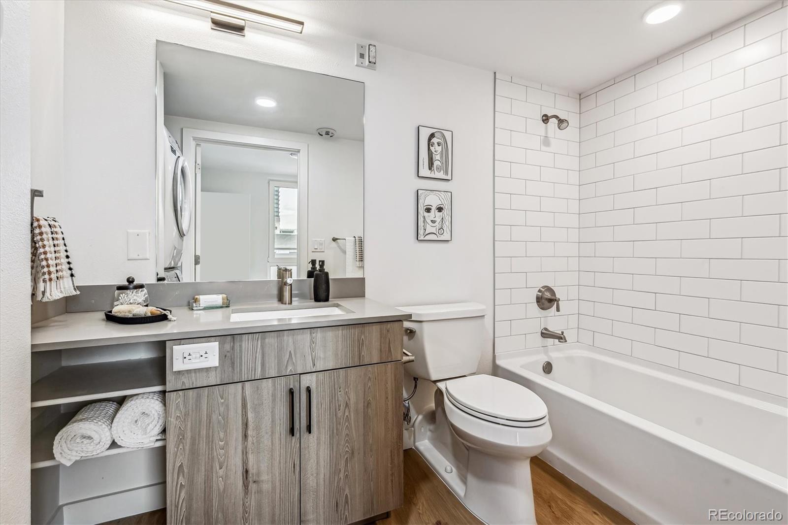 3575 Chestnut Place, Unit 605 Denver, CO 80216 - Photo 10 of 11 a bathroom with a sink a toilet and shower