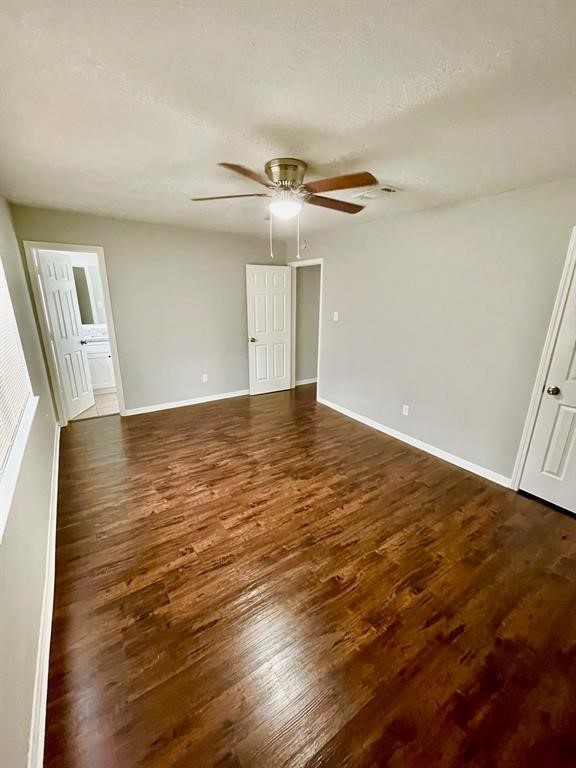 7700 Creekbend Drive, Unit 72 Houston, TX 77071 - Photo 12 of 21 an empty room with wooden floor fan and windows