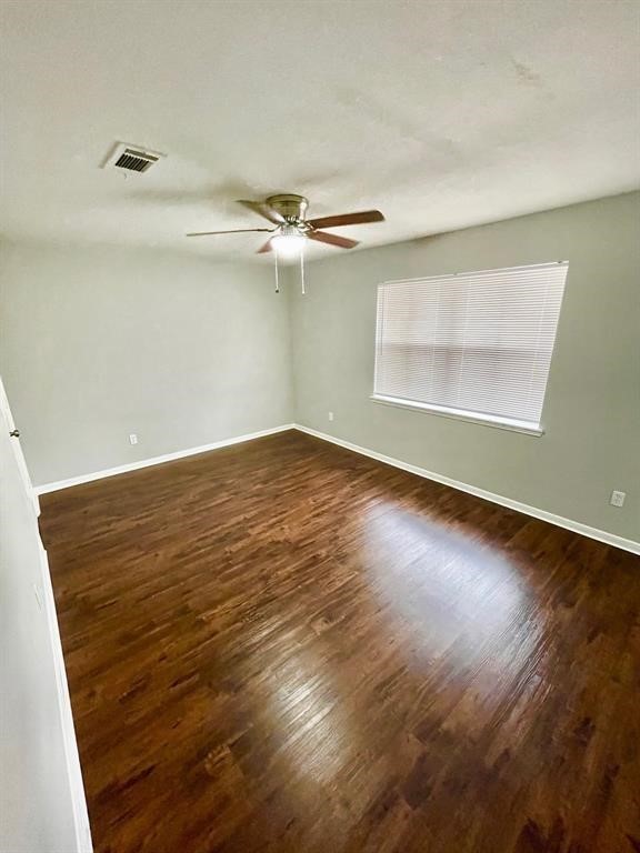 7700 Creekbend Drive, Unit 72 Houston, TX 77071 - Photo 13 of 21 an empty room with wooden floor fan and windows