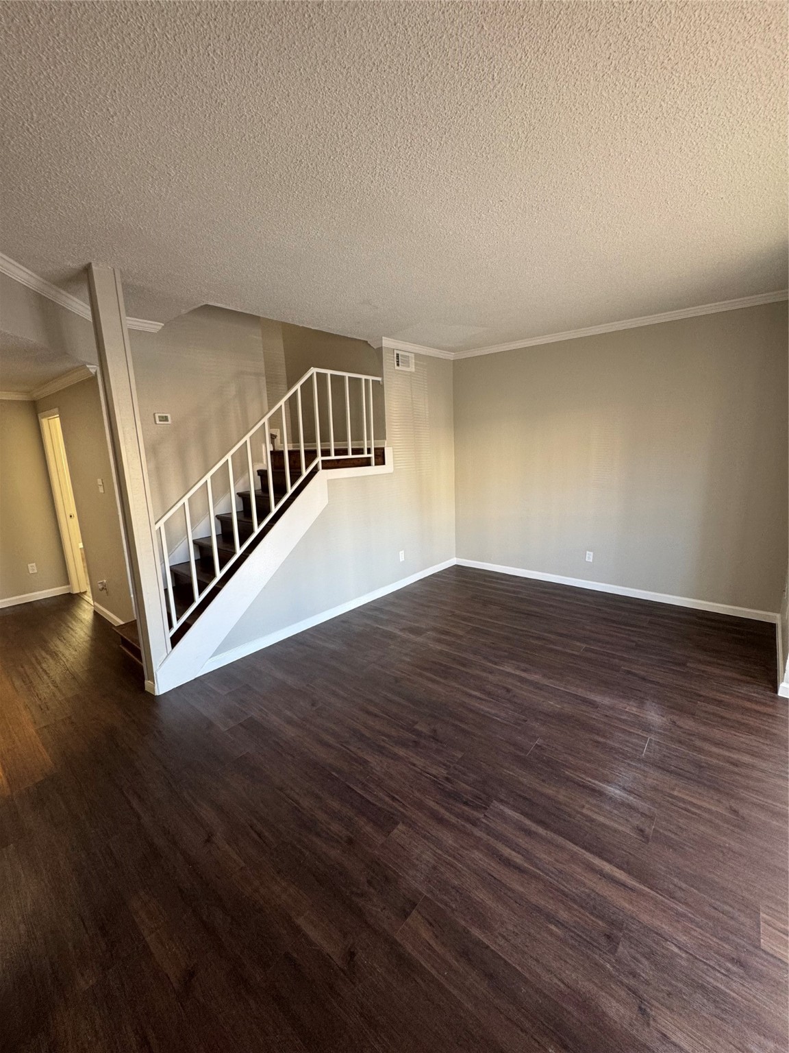 7700 Creekbend Drive, Unit 72 Houston, TX 77071 - Photo 6 of 21 a view of an empty room with wooden floor and stairs