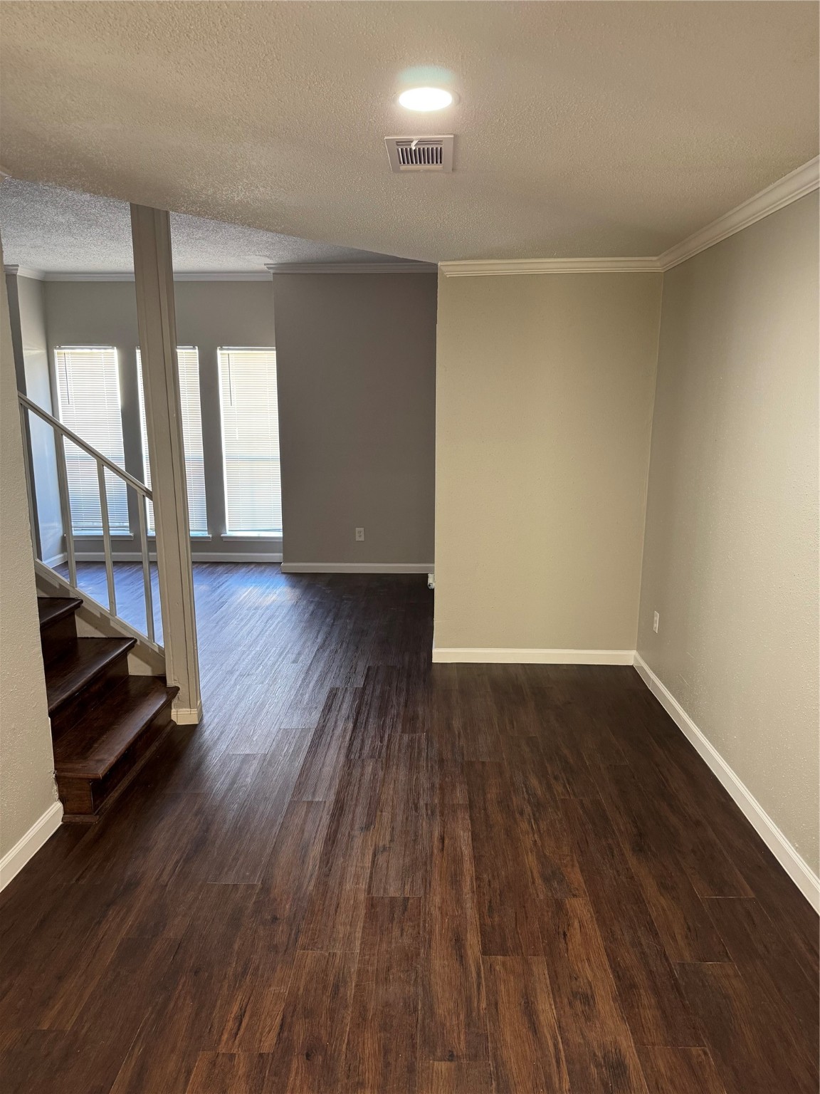 7700 Creekbend Drive, Unit 72 Houston, TX 77071 - Photo 7 of 21 a view of an empty room with wooden floor and a window
