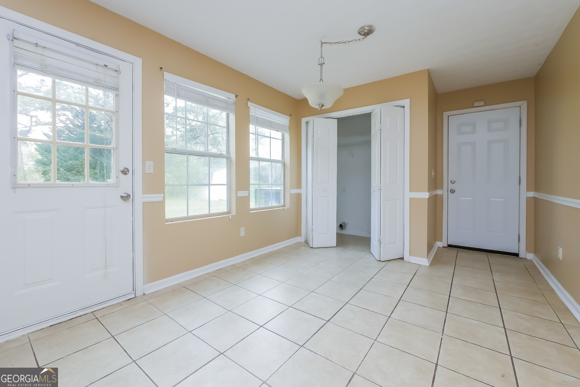 101 Bradesbury Lane Locust Grove, GA 30248 - Photo 10 of 17 a view of an empty room with window and chandelier