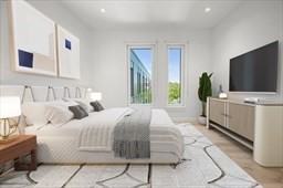 2149 Washington Street, Unit 604 Boston, MA 02119 - Photo 2 of 4 a bedroom with a bed and flat screen tv