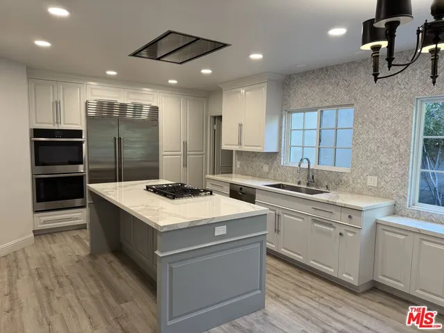 a kitchen with a stove and a sink