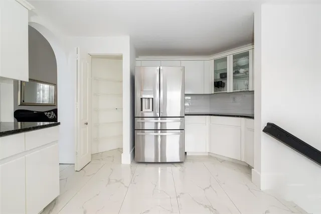 a bathroom with a sink a large mirror and a bathtub
