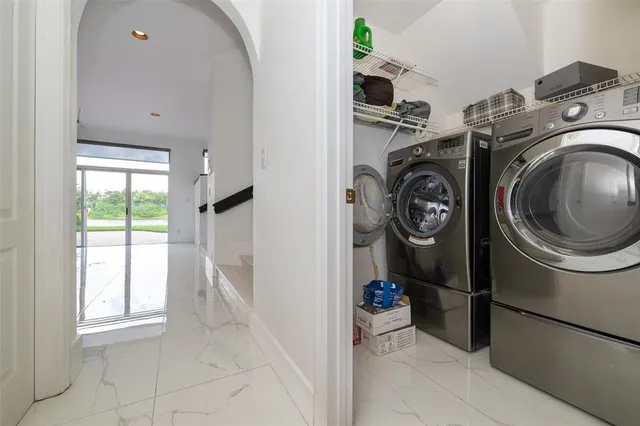 a living room with furniture and a book shelf