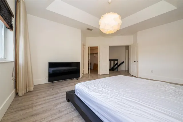 a view of a room with wooden floor and bathroom