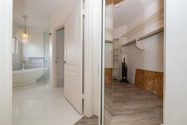 a view of a hallway with wooden floor and stairs