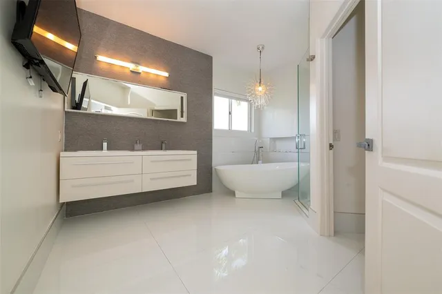 a view of a hallway with wooden floor and stairs