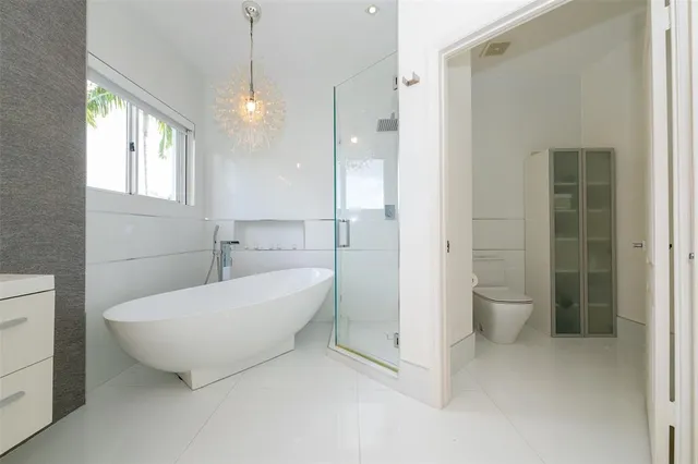 an empty room with a large window and mirror