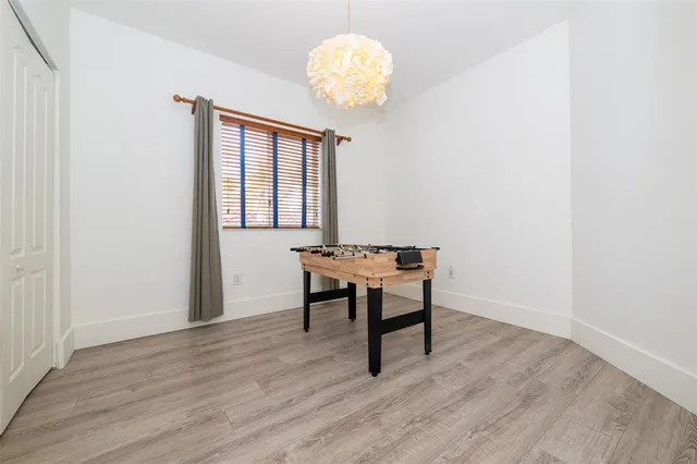 a view of a yard with plants and trees