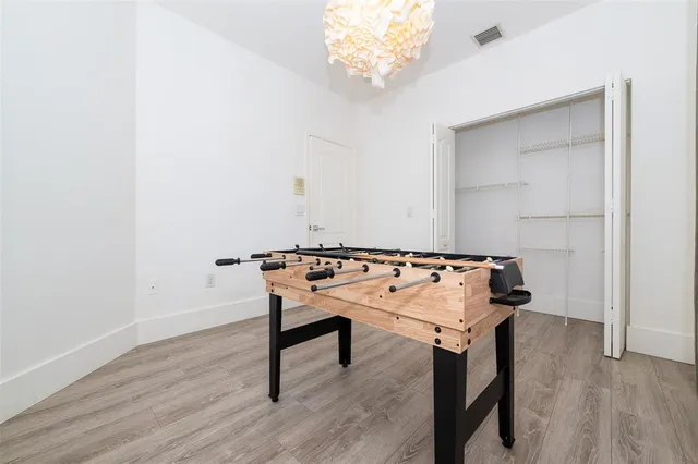 a view of a yard with plants and trees