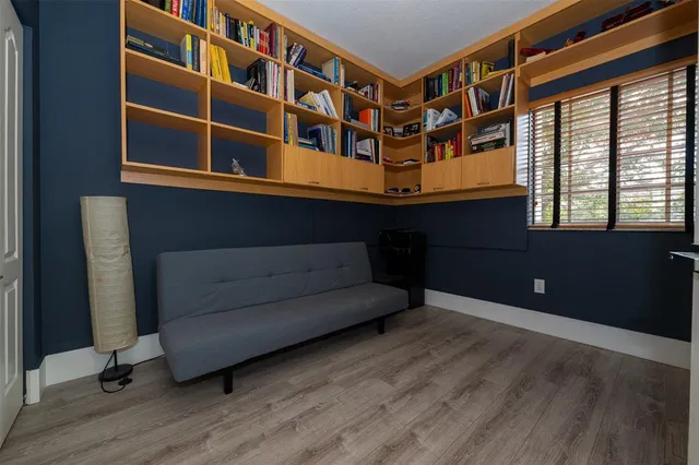 a front view of a house with a yard and potted plants