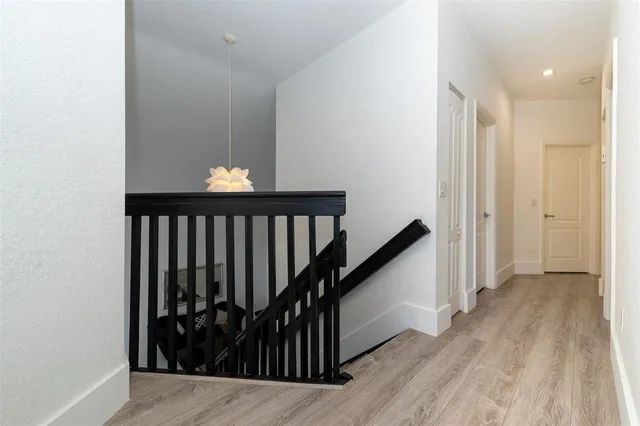 an aerial view of residential houses with outdoor space and parking