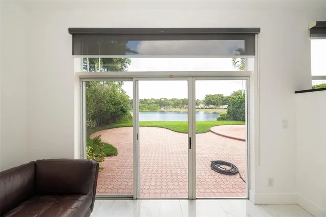 a view of a lake with a yard and outdoor seating