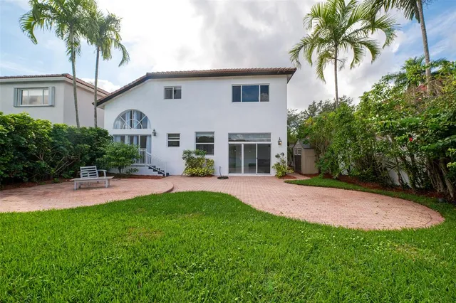 an aerial view of residential houses with outdoor space and swimming pool