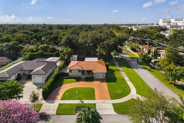 an aerial view of residential houses with outdoor space and street view