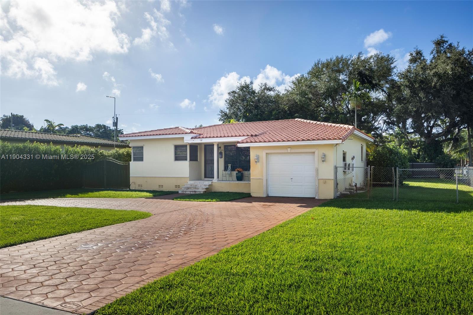 6040 Southwest 29th Street Miami, FL 33155 - Photo 12 of 18 a front view of a house with a yard and garage