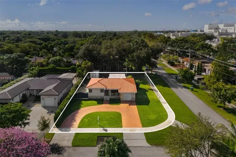 an aerial view of residential houses with outdoor space and lake view