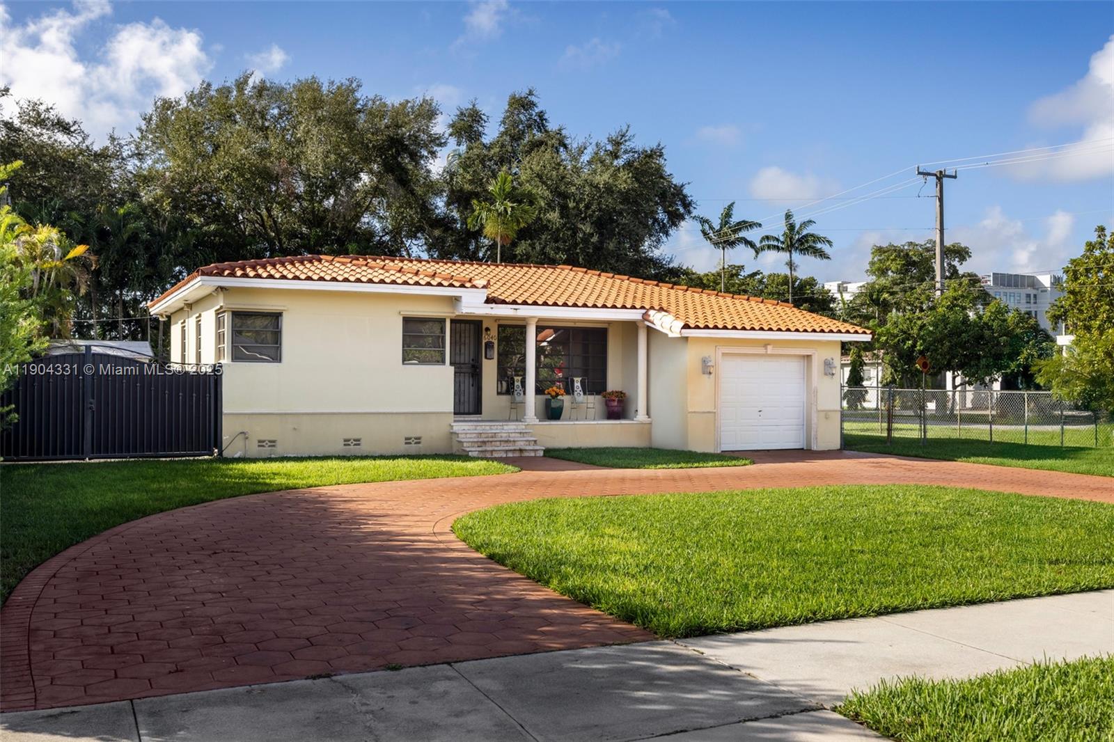 6040 Southwest 29th Street Miami, FL 33155 - Photo 7 of 18 a front view of a house with a yard and garage