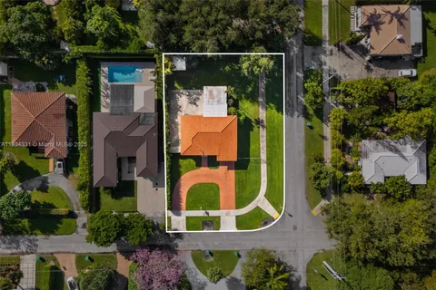 an aerial view of residential house with outdoor space and swimming pool