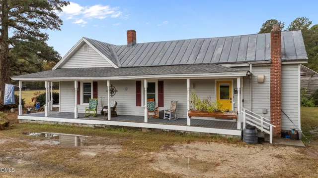 a front view of a house with a garden and porch