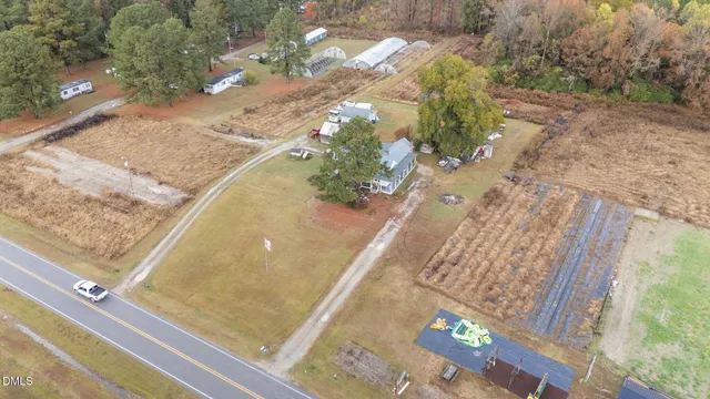 a view of a hallway with wooden floor and livingroom with dining room
