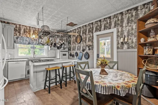 a living room with furniture chess board and a window