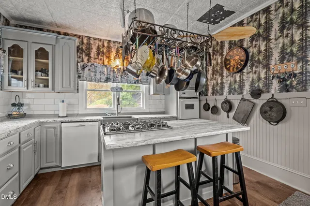 a bedroom with a bed a rug and dresser
