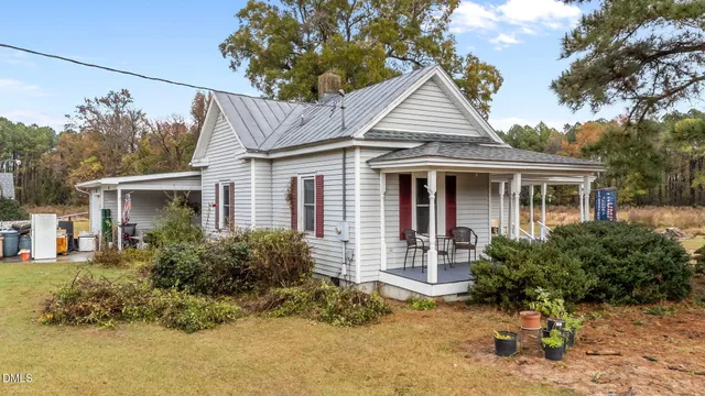 a front view of house with yard outdoor seating and barbeque oven