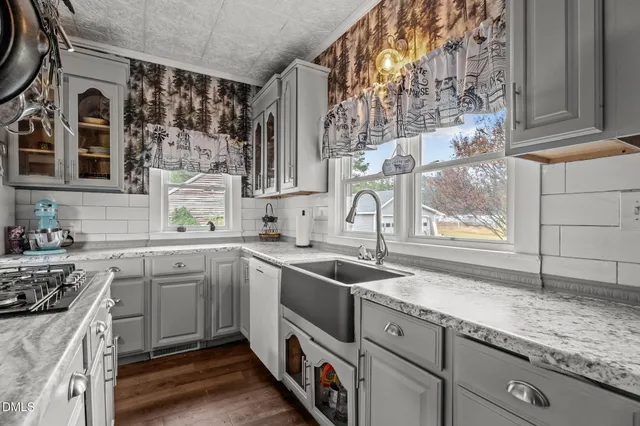 a room with furniture a flat screen tv and a refrigerator