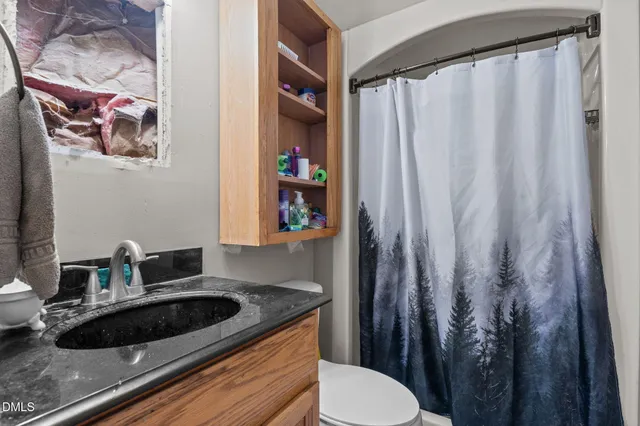 an aerial view of a house with yard and patio