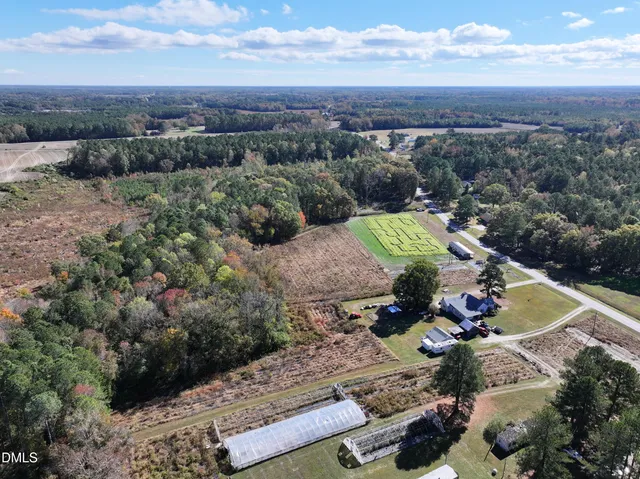 a view of a yard with a wooden fence