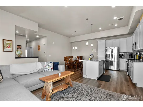 a living room with furniture and kitchen view
