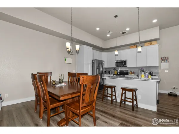 a view of a dining room with furniture and wooden floor