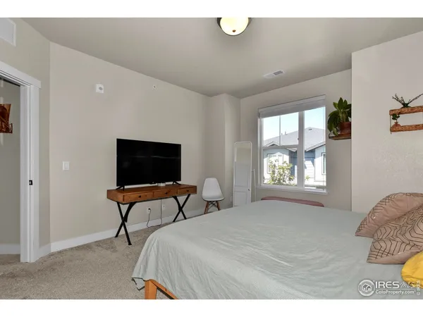 a bedroom with bed and window