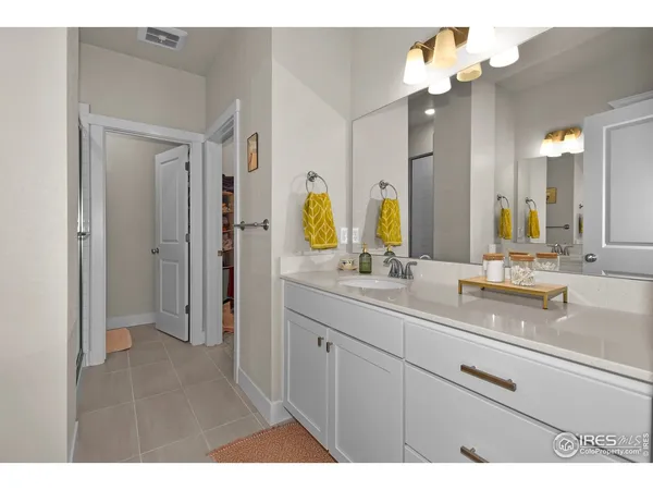a bathroom with a sink double vanity granite and a mirror