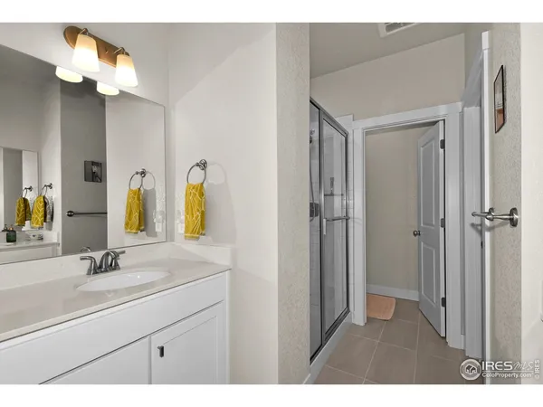a bathroom with a sink vanity and a mirror