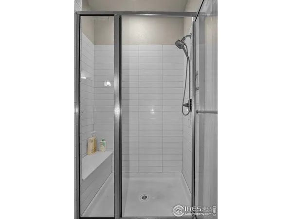 a bathroom with a glass shower door